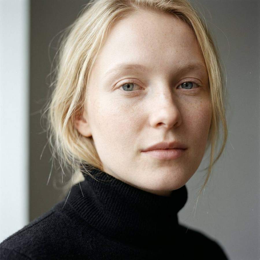 AI-generated portrait of a blonde woman in a black turtleneck
