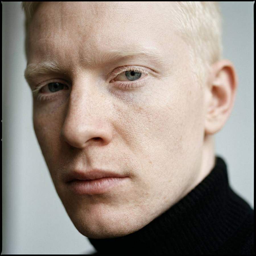 AI-generated portrait of a man with white-blond hair in a black turtleneck