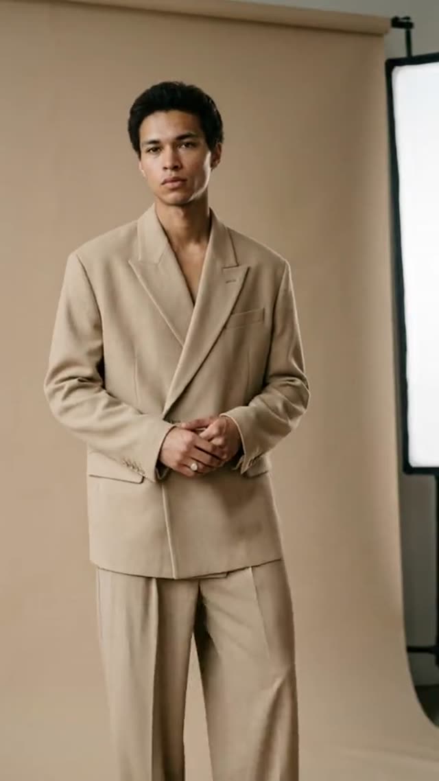 AI fashion video: a man in a beige suit in a photo studio